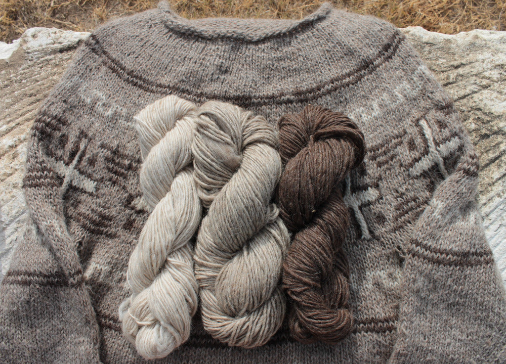 Example of yarn used to craft the Dine motif sweater shown with complete sweater. The yarn is Bone, Slate and Walnut